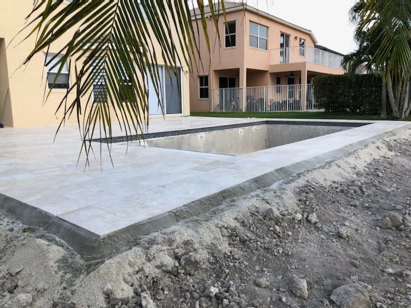 Pool construction progress with deck and shell