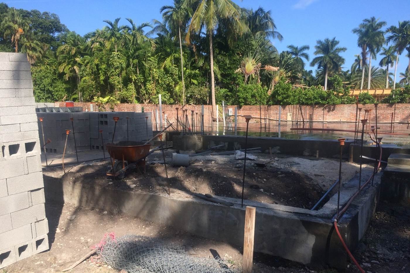 Block shell construction with field crew preparing site layout